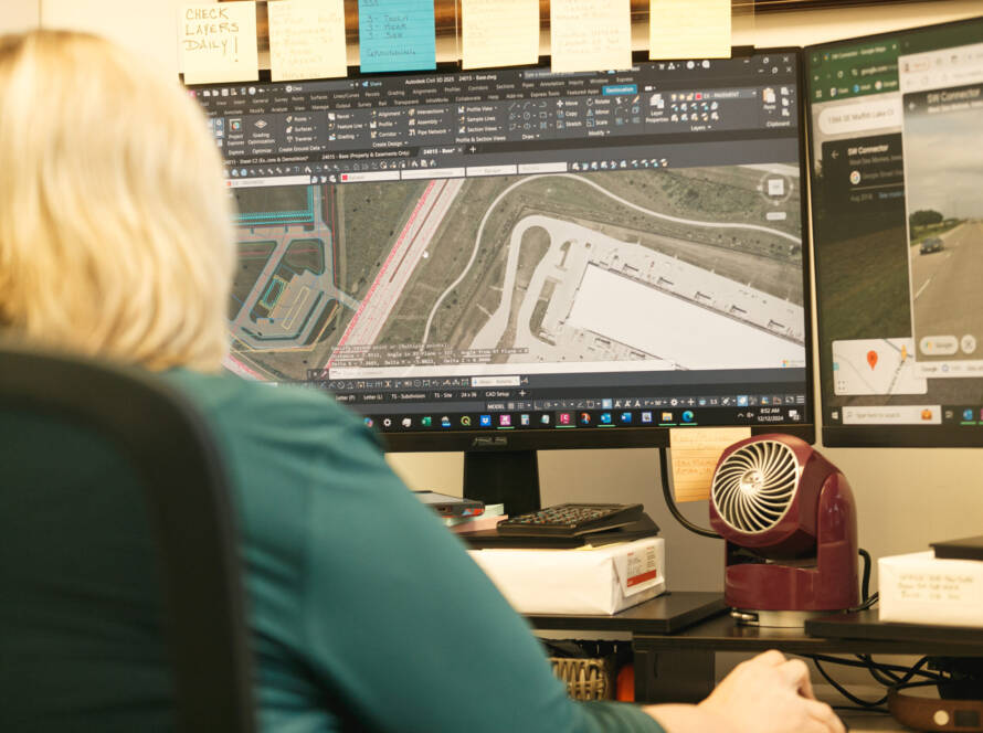 Civil engineer reviewing a site grading plan to ensure proper drainage and land development